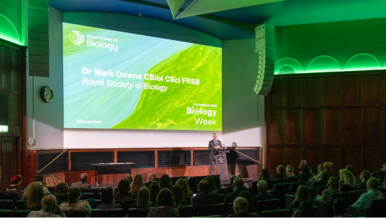 RSB Chief Executive Dr Mark Downs CBiol CSci FRB presenting at the awards ceremony in front of projector screen